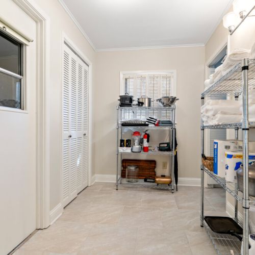 Laundry room with ample storage and back entrance and exit from the covered carport/garage area