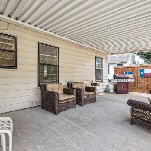 Covered back porch with gas grill and plenty of seating