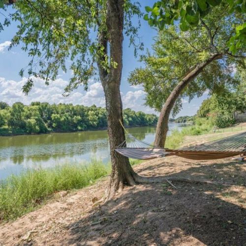 Relax on the hammock by the banks of the Brazos River under the shady trees